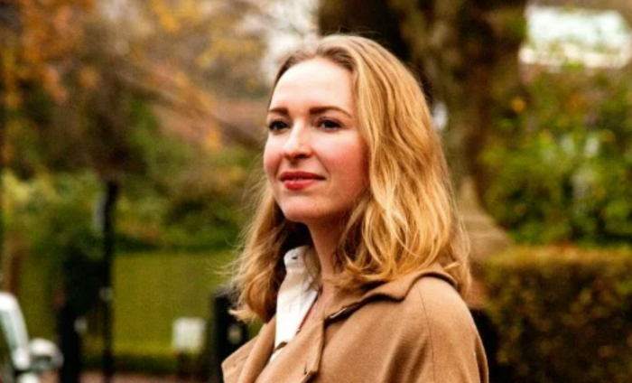 Photo of Wren Loucks with green scenery in the background