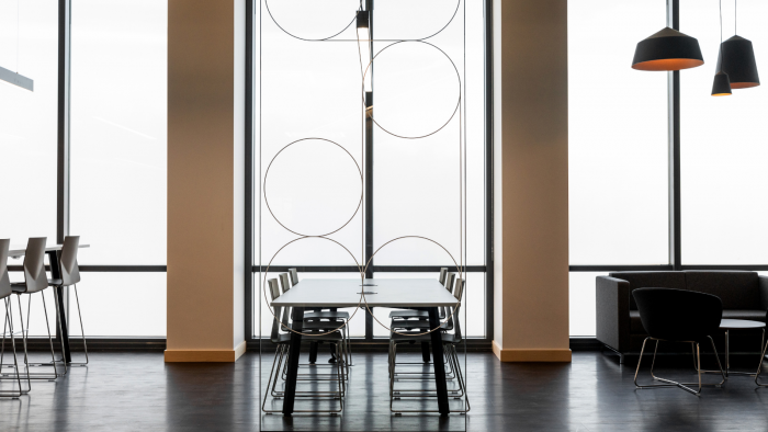 Level 50 space in Canary Wharf showing desks and sky view windows